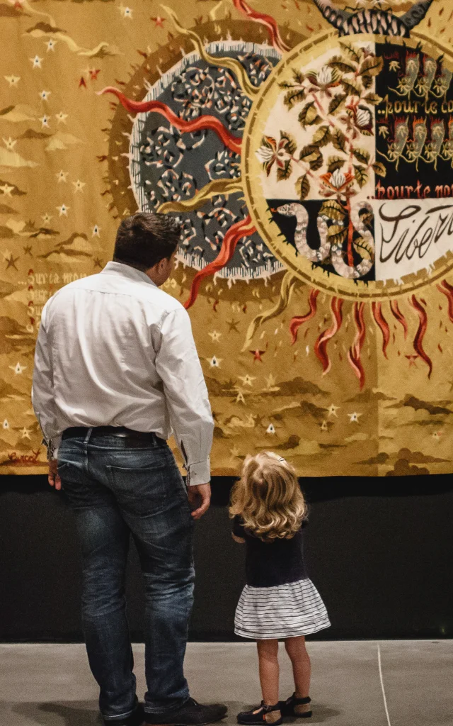 A father and daughter in front of a tapestry, Jean Lurçat temporary exhibition, Musée des Beaux-Arts, Angers