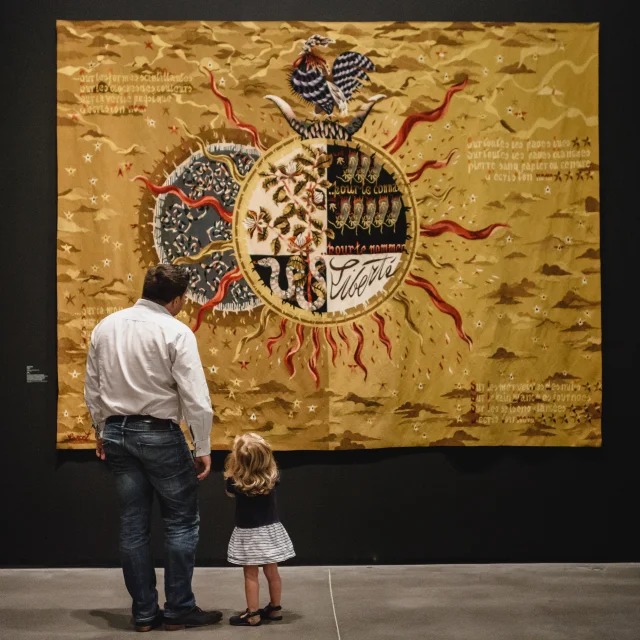 A father and daughter in front of a tapestry, Jean Lurçat temporary exhibition, Musée des Beaux-Arts, Angers