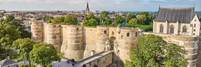 Drone view of the Château d'Angers, entrance and drawbridge side, soft morning light, sunny sky