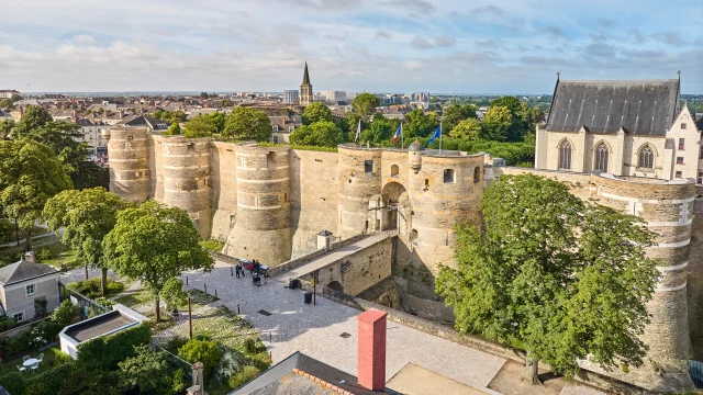 Drone view of the Château d'Angers, entrance and drawbridge side, soft morning light, sunny sky