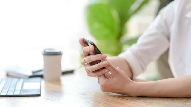 Close up. Woman hand using smartphone order goods online.