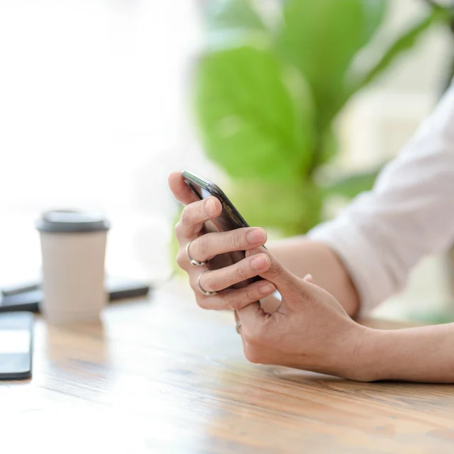 Close up. Woman hand using smartphone order goods online.