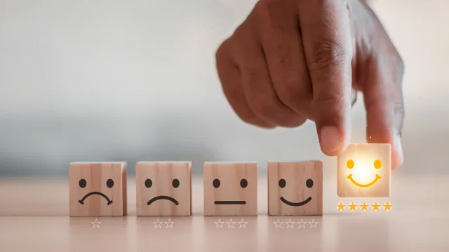 customer services best excellent business rating experience. Satisfaction survey concept. Hand of a businessman chooses a smiley face on wood block cube. 5 Star Satisfaction