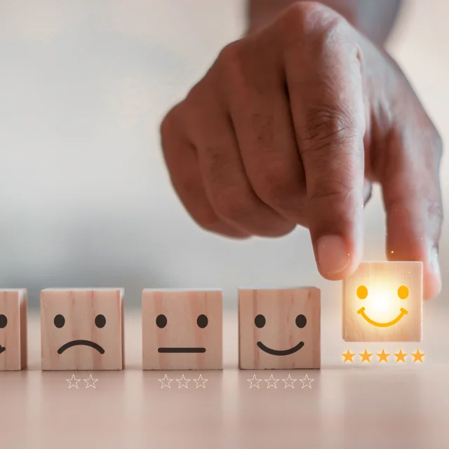 customer services best excellent business rating experience. Satisfaction survey concept. Hand of a businessman chooses a smiley face on wood block cube. 5 Star Satisfaction